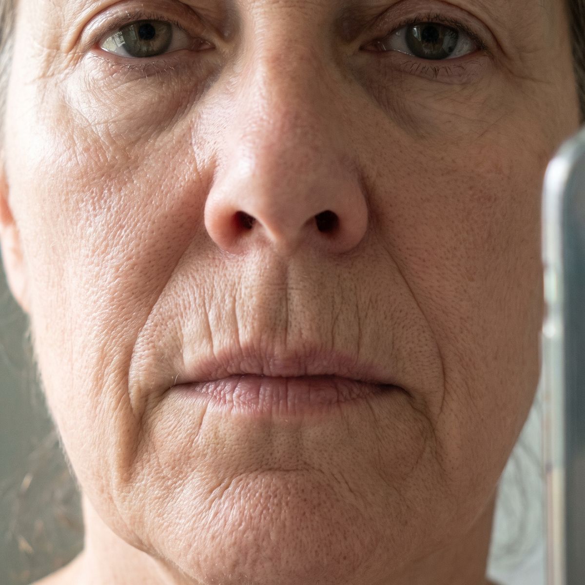 Gros plan sans retouche sur le visage d'une femme mature, rides verticales au-dessus de la lèvre